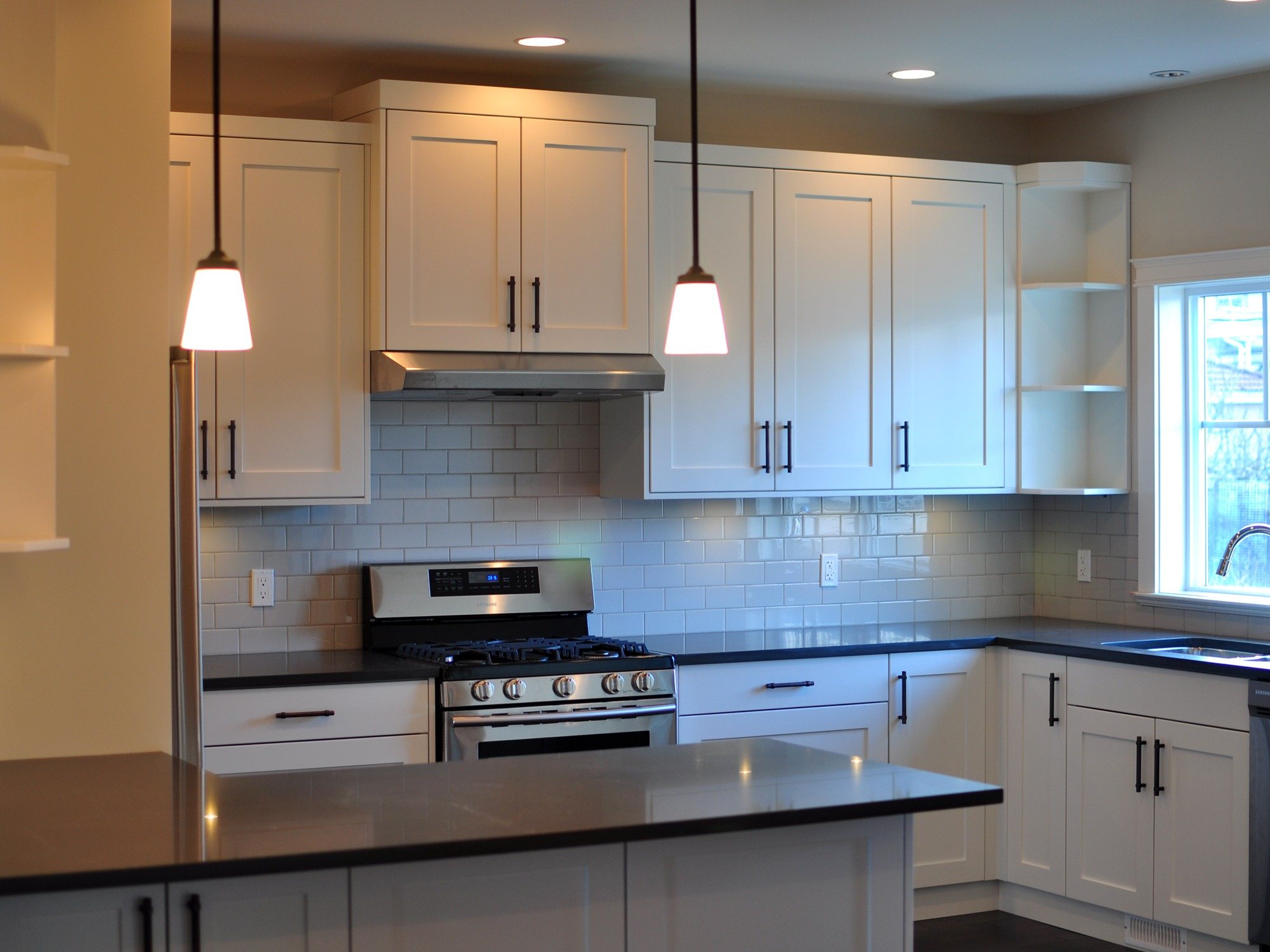 Completed residential kitchen renovation with white cabinetry